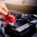 A technician inspecting a car battery