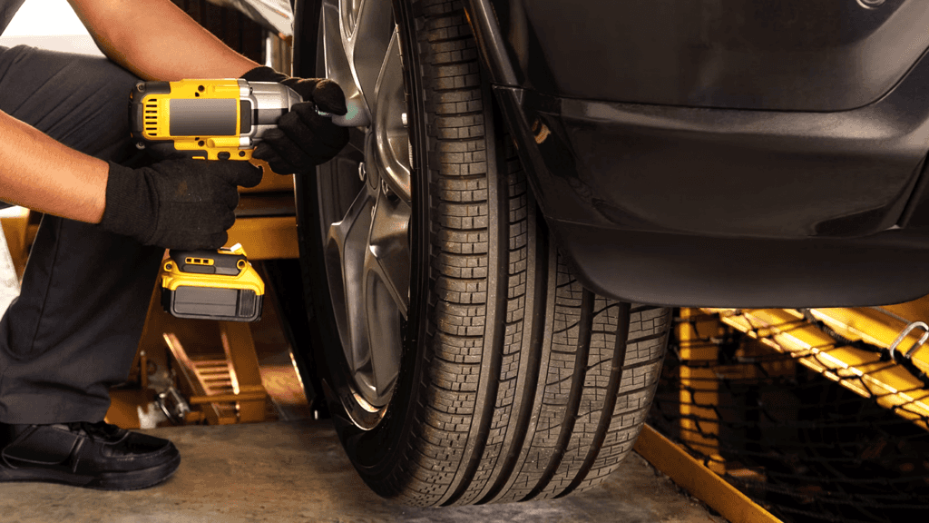 A technician performing a tire rotation