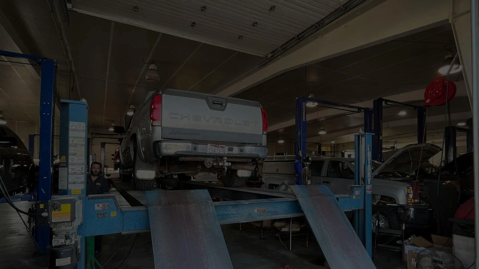 Certified Chevy Technician working on a Chevy truck at the service bay at Bud Clary Chevrolet of Moses Lake