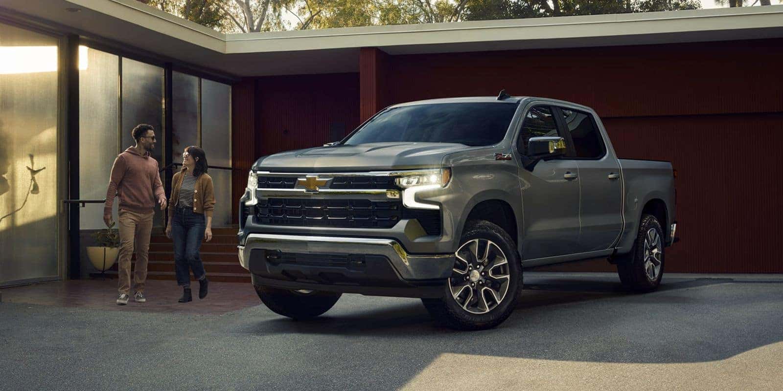 Couple walking out to a new Chevrolet Silverado 1500 pickup