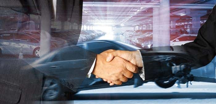 shaking hands after leasing new Subaru
