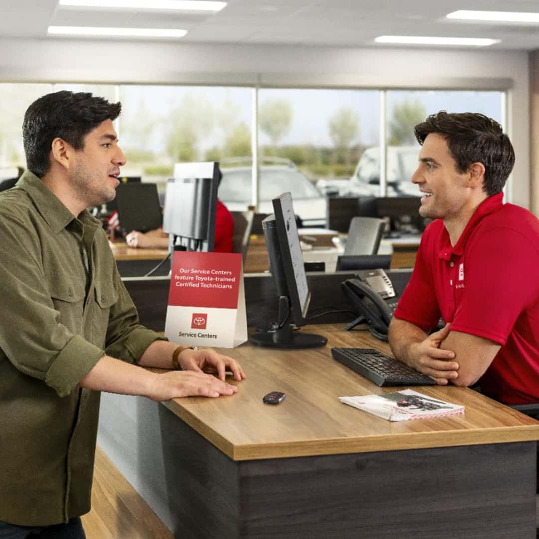 2 man discussing Toyota vehicles and service