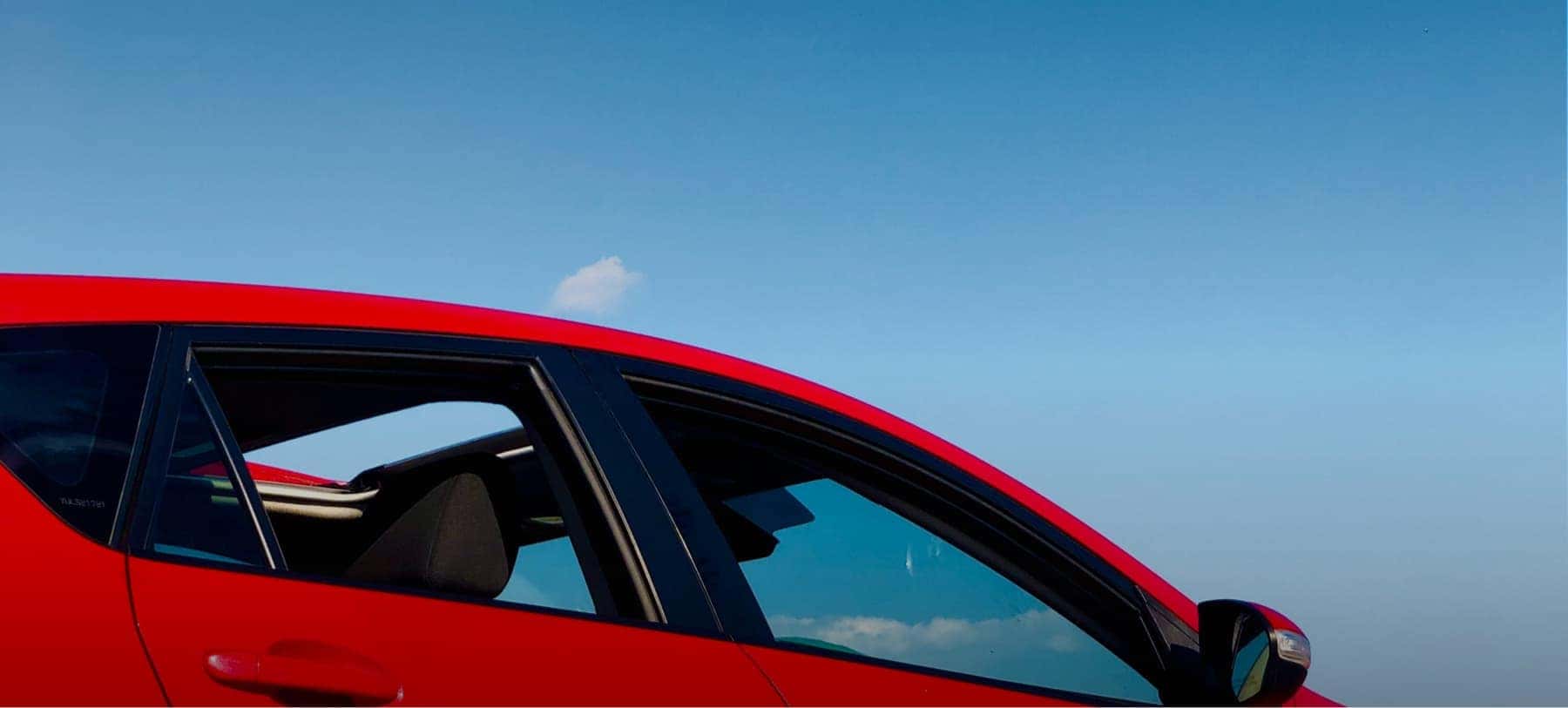 Red vehicle with a blue sly background