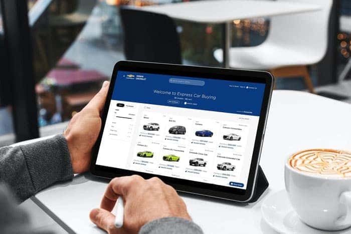 Person shopping for vehicles on their tablet