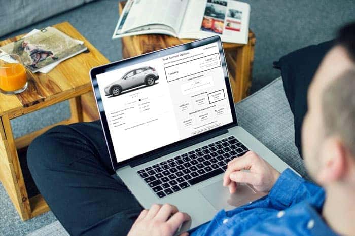 Person shopping for a vehicle on their laptop