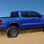 New Chevy Colorado driving up a sand dune