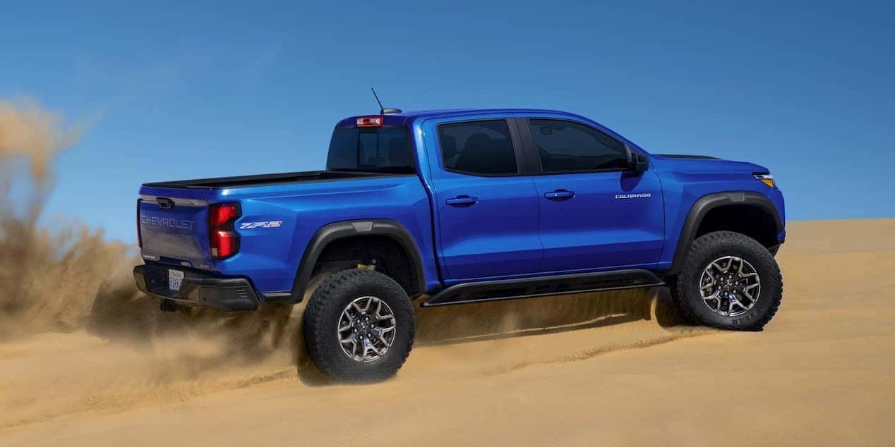 New Chevy Colorado driving up a sand dune