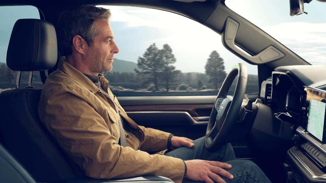 Man sitting in the driver's seat of the Silverado 1500