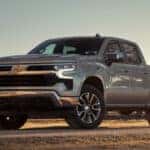 2025 Chevy Silverado parked beside a farm fence line