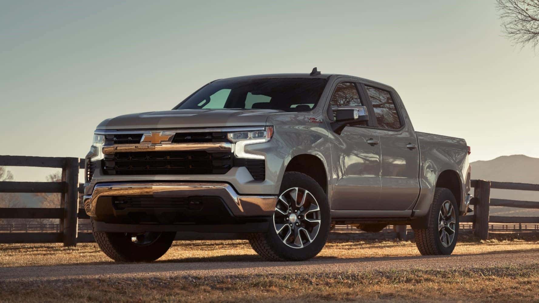2025 Chevy Silverado parked beside a farm fence line