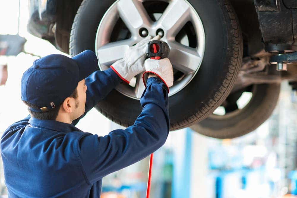 2024 Chevrolet Silverado EV Preview Service technician installing a tire