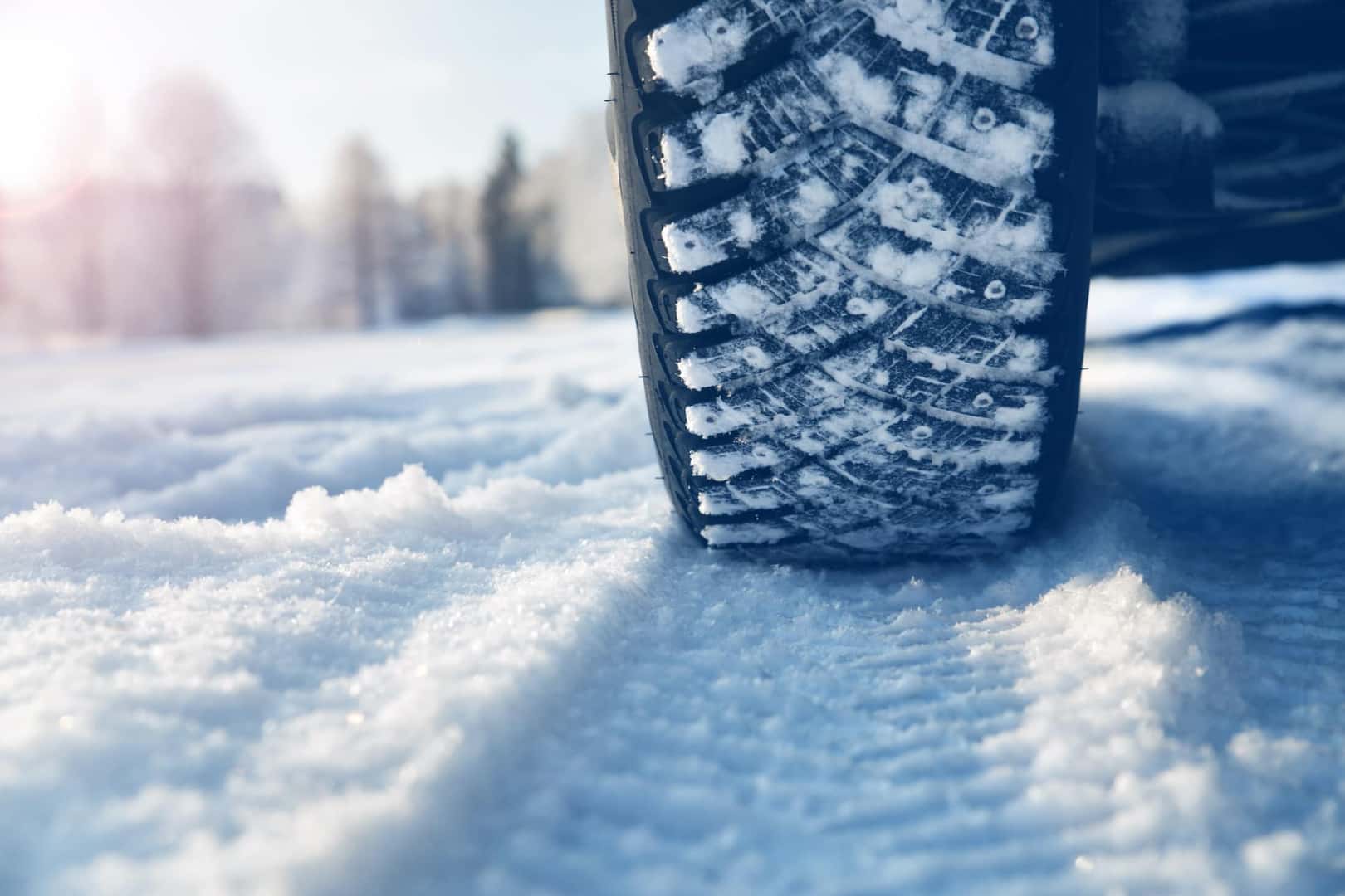 Close-up view of a tire driving over snow