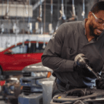 A Chevy service technician working under the hood of a vehicle
