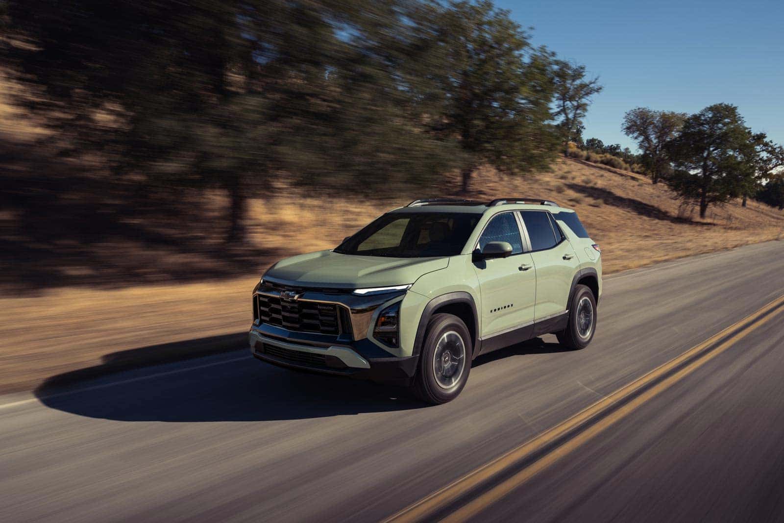 2026 Chevrolet Equinox driving near Denver as a best compact SUV option compared with GMC Terrain