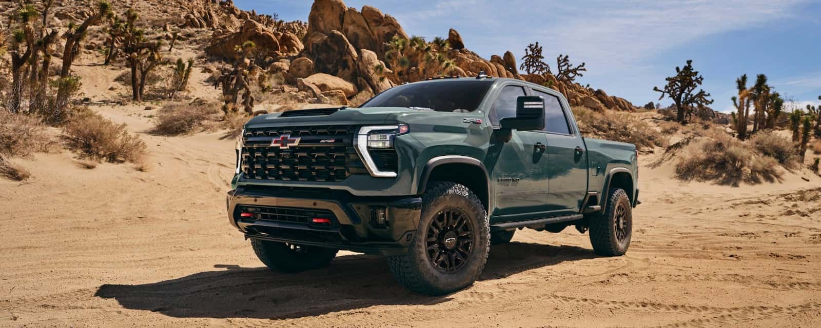 2026 Chevrolet Silverado HD with available Duramax 6.6L Turbo-Diesel V8 driving off-road — official Chevrolet image