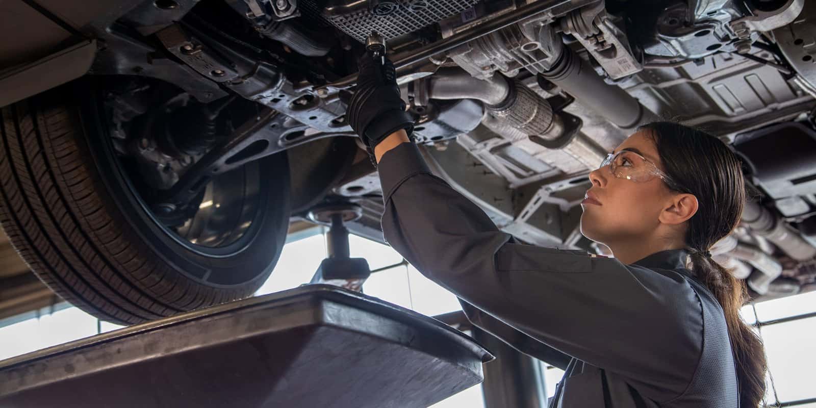 Certified Chevrolet service technician performing maintenance at Emich Chevrolet in Lakewood, CO