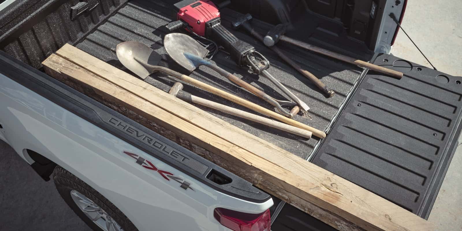 Durabed cargo bed of the 2026 Chevrolet Silverado loaded with construction equipment