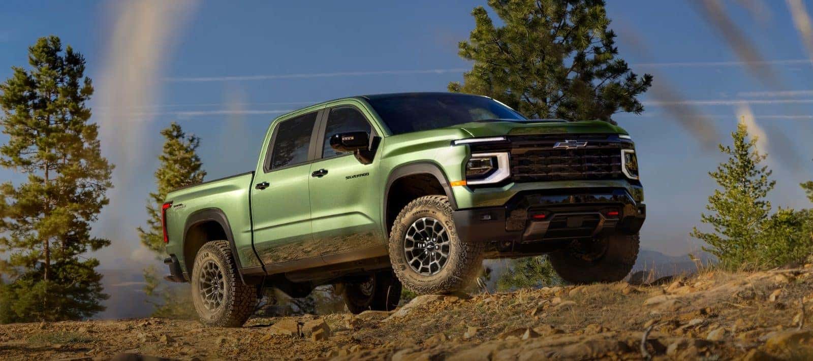Green 2027 Chevy Silverado 1500 ZR2 on a forest trail