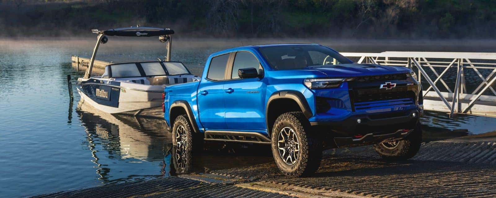 2026 Chevy Colorado towing a boat at a lake dock