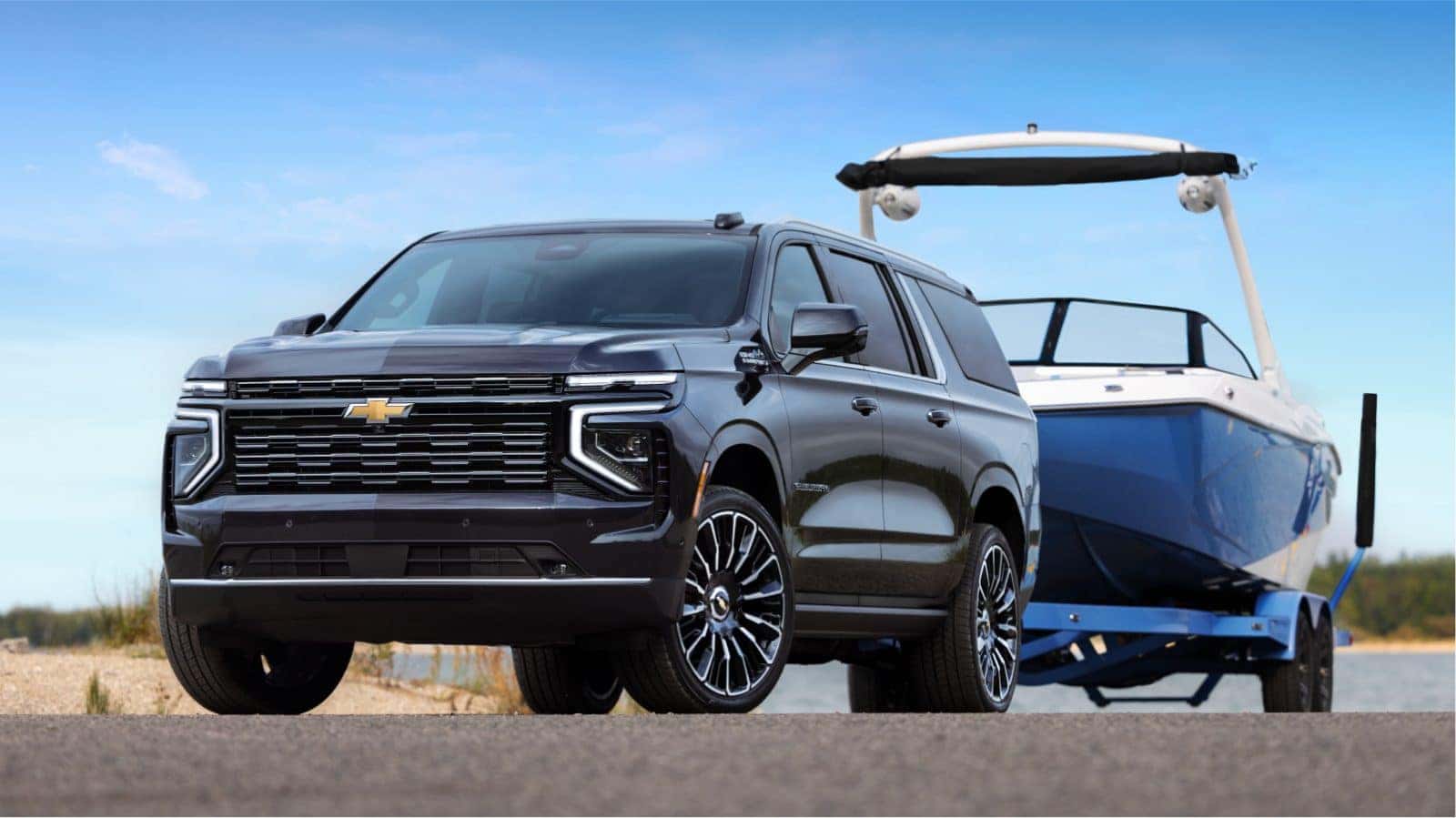 Chevy Suburban towing a boat at the lake