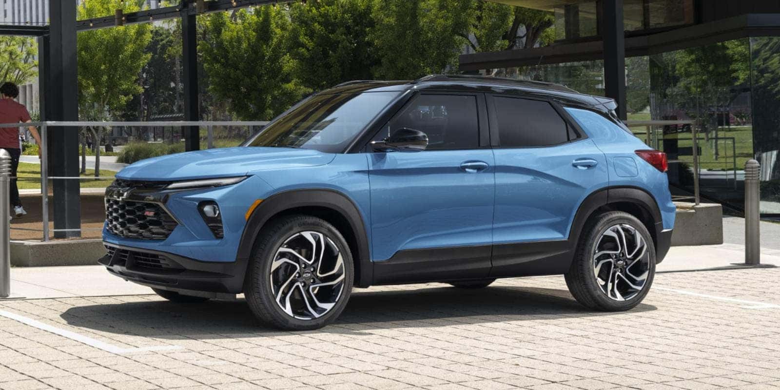 Blue Chevy Trailblazer parked outside a modern building