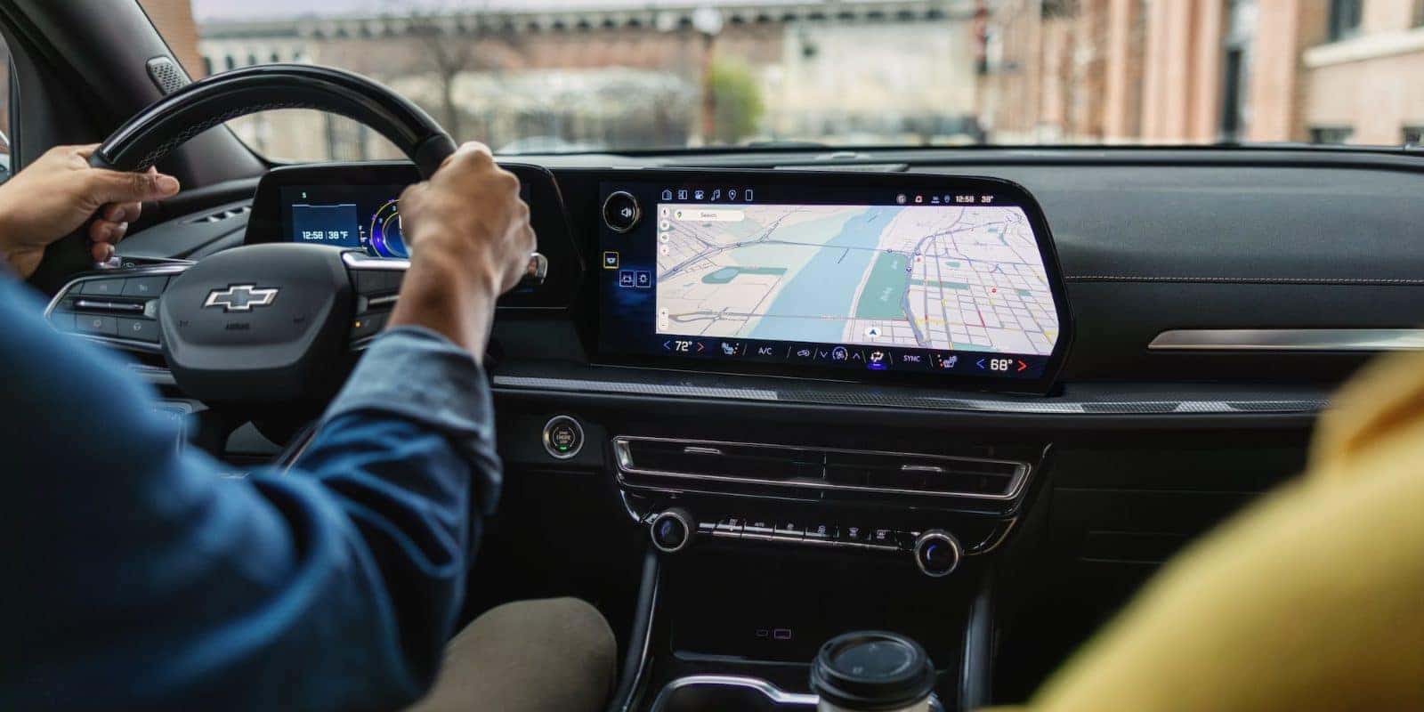 Driver using navigation on the Chevy Traverse touchscreen