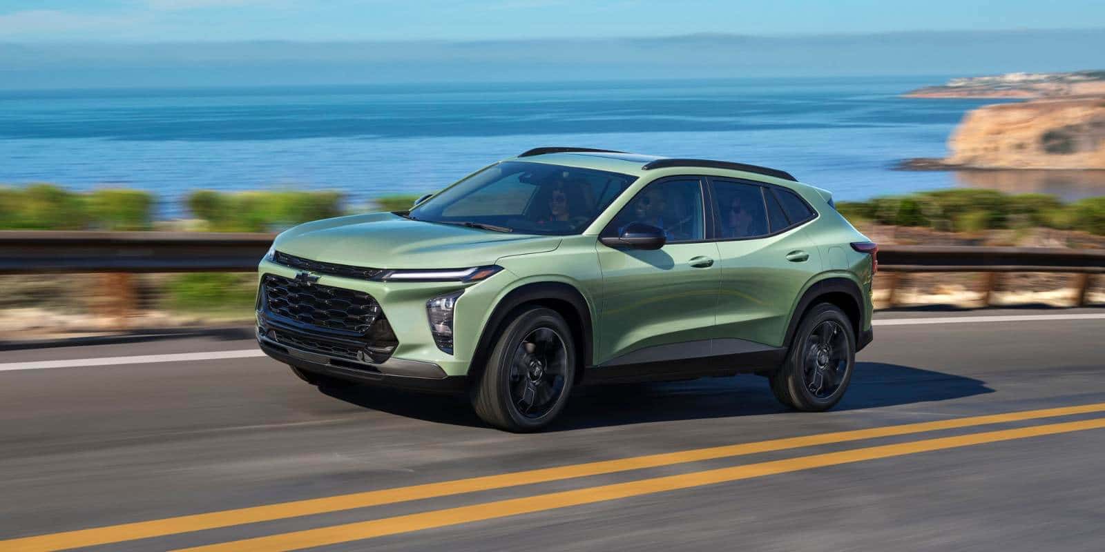 Light green Chevy Trax driving on a coastal road