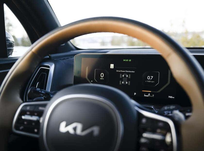 Driver-perspective interior view of a Kia Sorento highlighting the digital cluster screen.