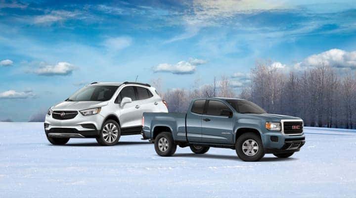 A Buick and GMC vehicle parked outside the snow.