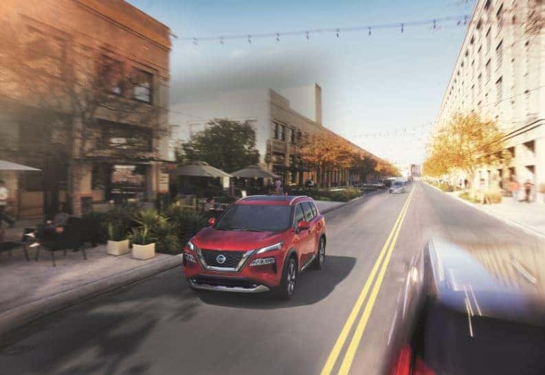 2021 Nissan Rogue Platinum in Red - Driving Down City Street