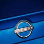 Blue Nissan with Nissan Logo on back of car