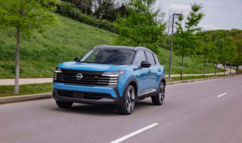 Blue 2025 Nissan Kicks driving down highway