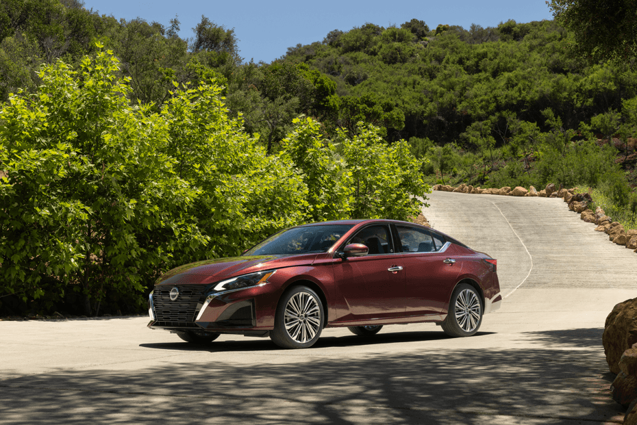 Side profile Nissan Altima driving down street