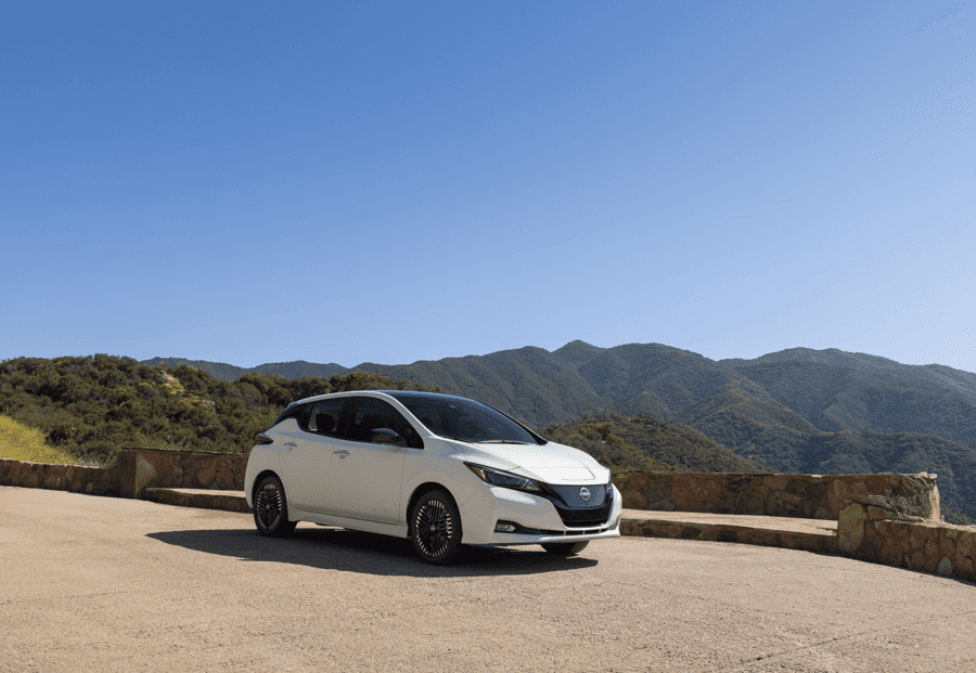 White Nissan LEAF EV outside with mountains