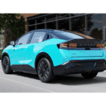 Back of new 2026 Nissan LEAF driving down highway
