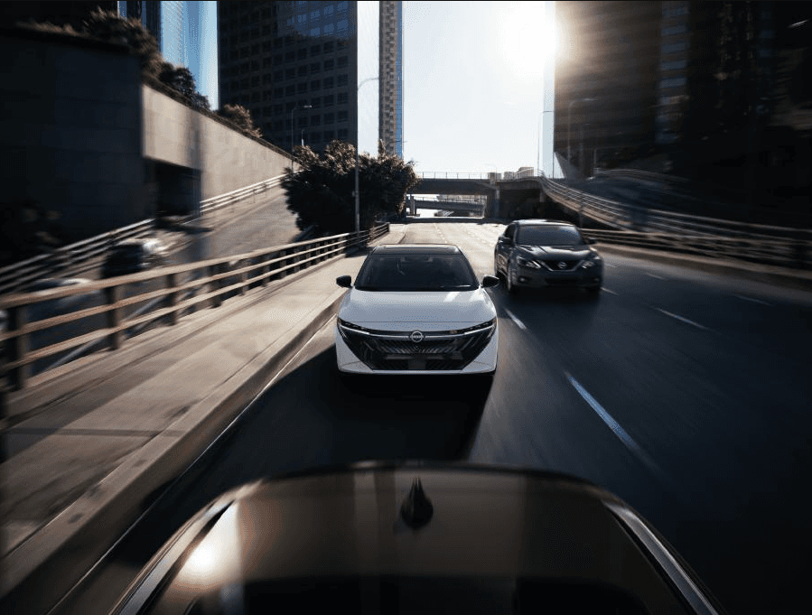 View of white 2026 Nissan Sentra driving down highway