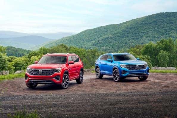 Red 2024 VW Atlas and Blue 2024 VW Atlas Cross Sport