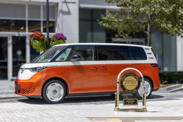 Orange VW ID. Buzz with J.D. Power Award in front 