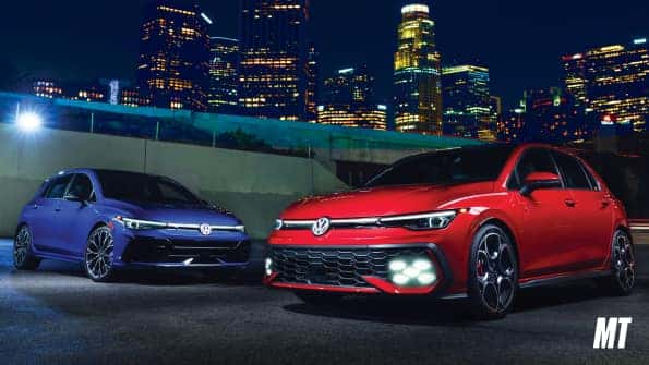 Red and Blue 2026 VW Golf GTI with city lights in background