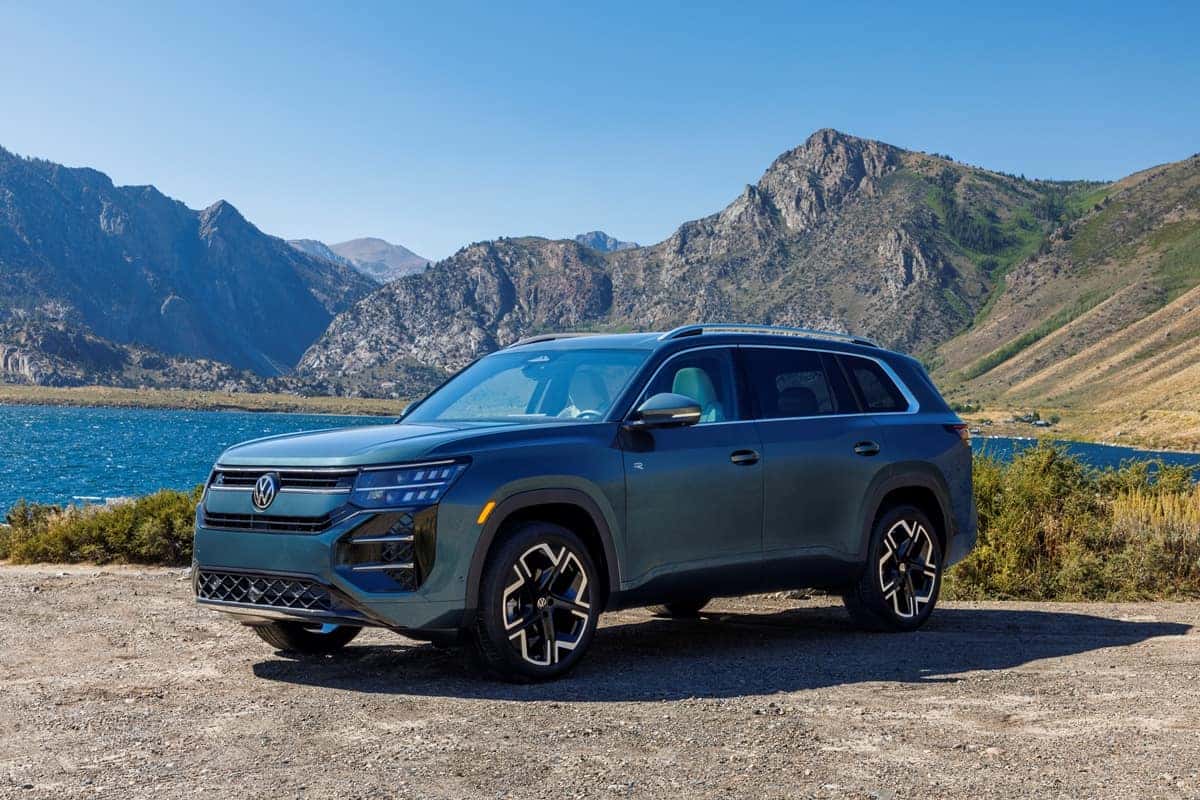 2027 Volkswagen Atlas in Sacramento Green beside a mountain lake