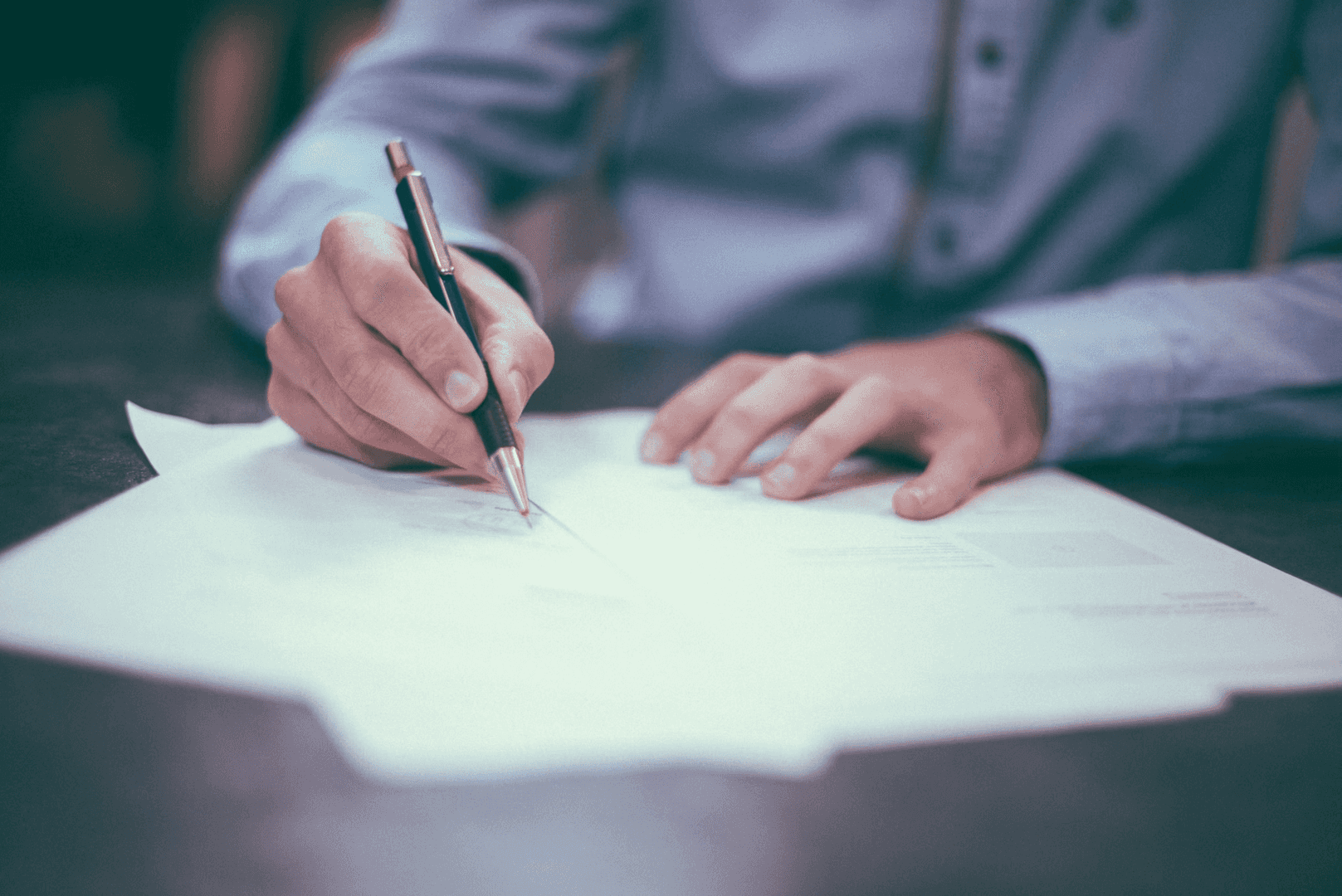 Guy signing a loan contract 