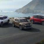 cars on a road in front of water