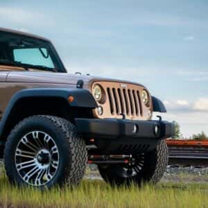a jeep is parked in a field of grass