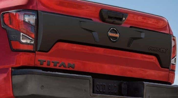 The tailgate and badging is shown on a red 2021 Nissan Titan Pro4x.