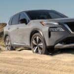 A gray 2021 Nissan Rogue is driving on a sand dune after leaving Nashville Nissan dealer.