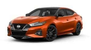 An orange 2021 Nissan Maxima is angled left.