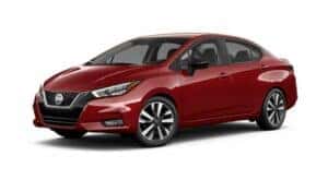 A red 2021 Nissan Versa is angled left.