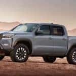 A gray 2022 Nissan Frontier Pro4x is shown parked on the dirt.