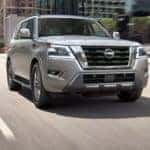 A grey 2022 Nissan Armada is shown from the front driving through a city after leaving a Nashville car dealership.