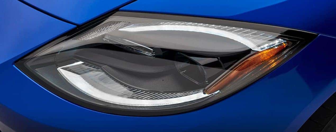 A close up shows the driver side headlight on a blue 2023 Nissan Z.